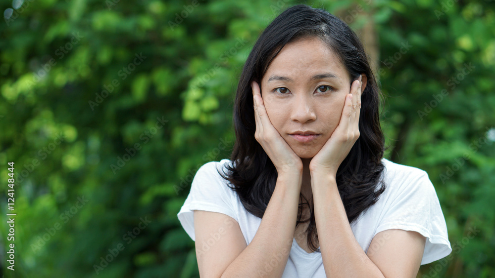 South East Asian girl looking at camera green background South East Asian girl looking at camera green background