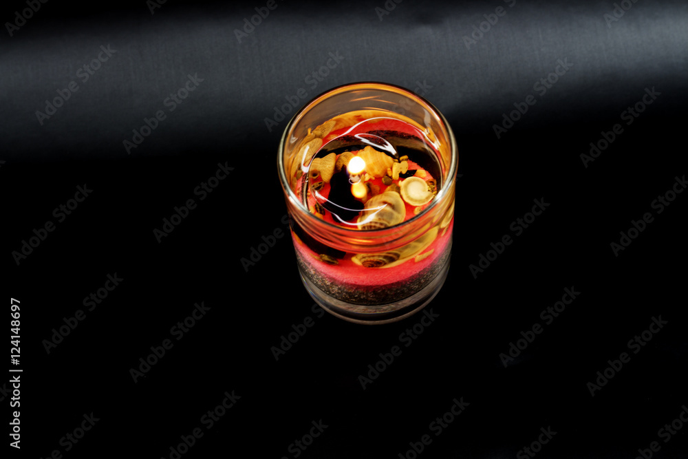 candle in glass on dark background