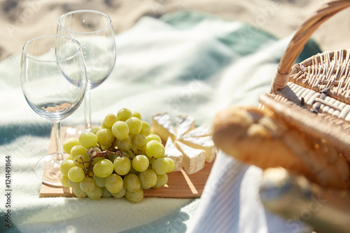 picnic with wine glasses and food on beach
