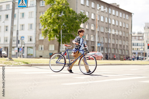 young man with fixed gear bicycle on crosswalk