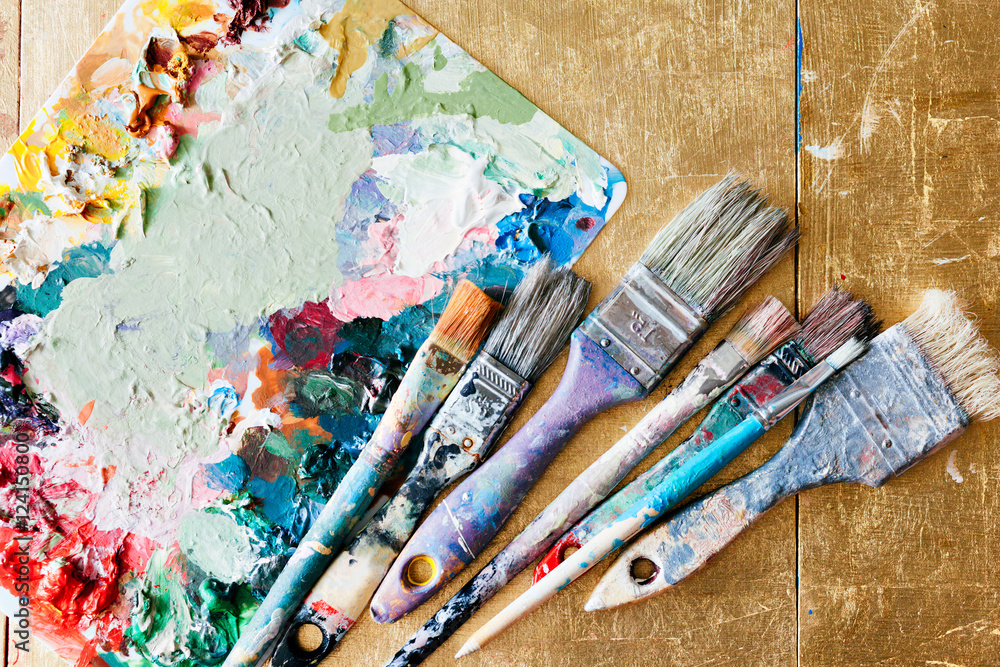 Fototapeta premium Brushes with palette in the creative background. Colorful element.