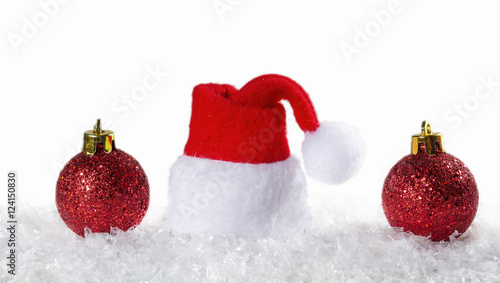 Christmas background with Christmas balls and cap of Santa Claus