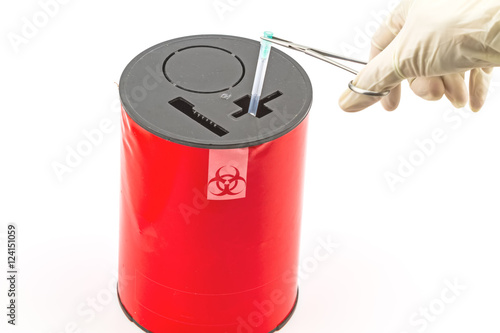 Doctor put needle in red disposal boxes on white background