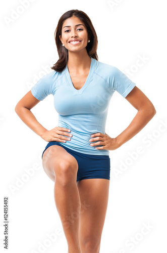 Young Latin Hispanic fitness aerobics body sculpting cardio exercising woman isolated on white background © Eric Hood