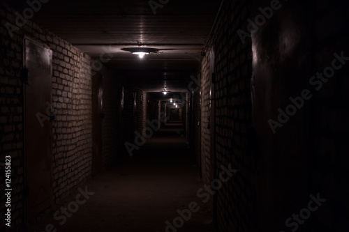 Dark long corridor hallway in a basement