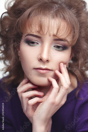 Gentle beauty portrait of a young girl with Nude make-up on a light gray background.