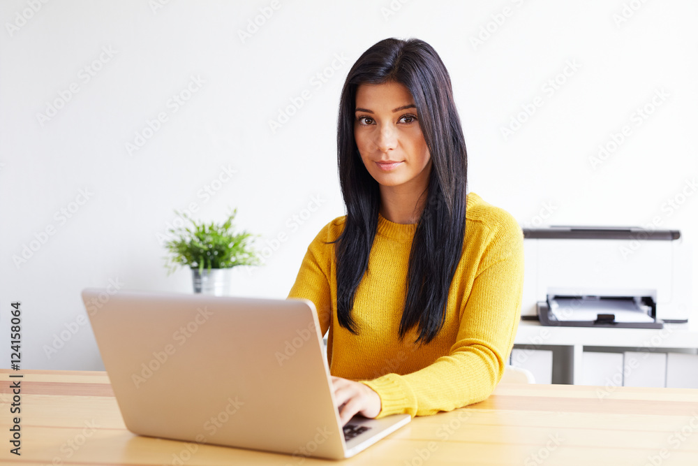 Woman typing on laptop in home office Woman typing on laptop in home office