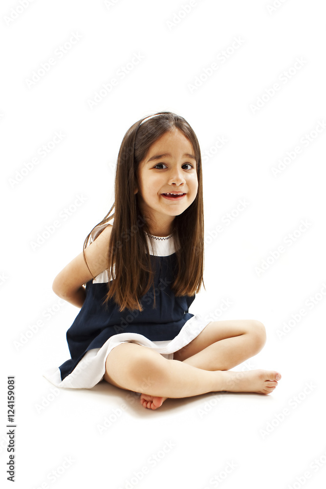 Foto de Upset little girl hide something behind back. Isolated on white  background do Stock