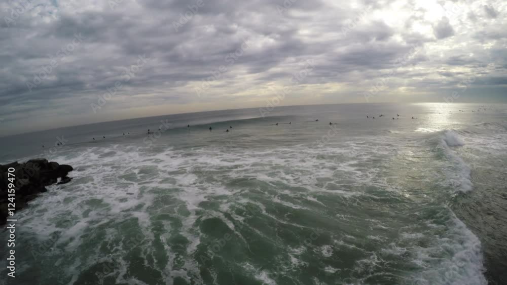 California Surfing aerials, large group of surfers near jetty, shot at Newport Beach, California. California Surfing aerials, large group of surfers near jetty, shot at Newport Beach, California.