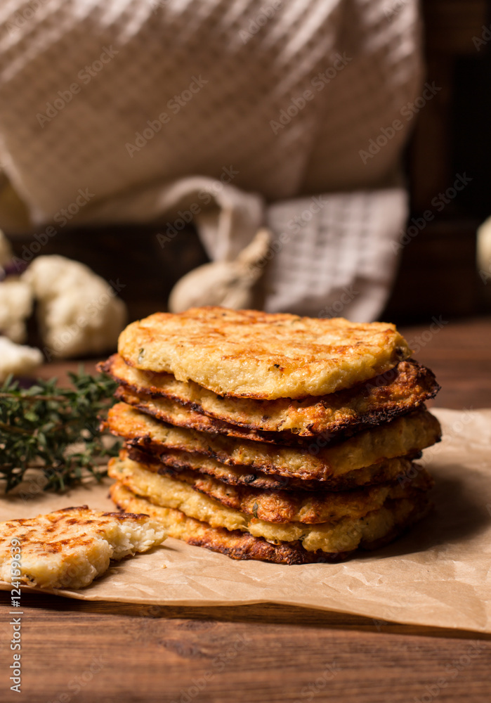 Hash browns cauliflower on a brown wooden background, selective focus, horizontal vertical Hash browns cauliflower on a brown wooden background, selective focus, horizontal vertical