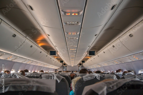 Interior of airplane with passengers on seats