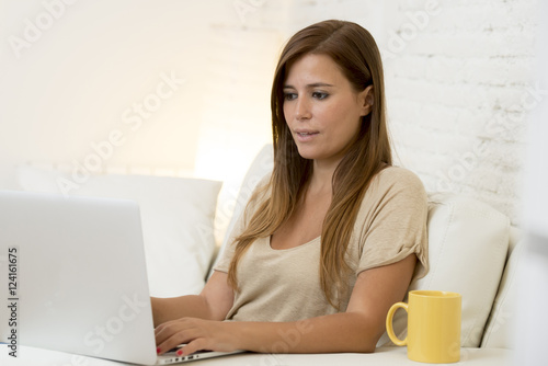 young beautiful woman working with laptop computer smiling happy or doing online internet shopping