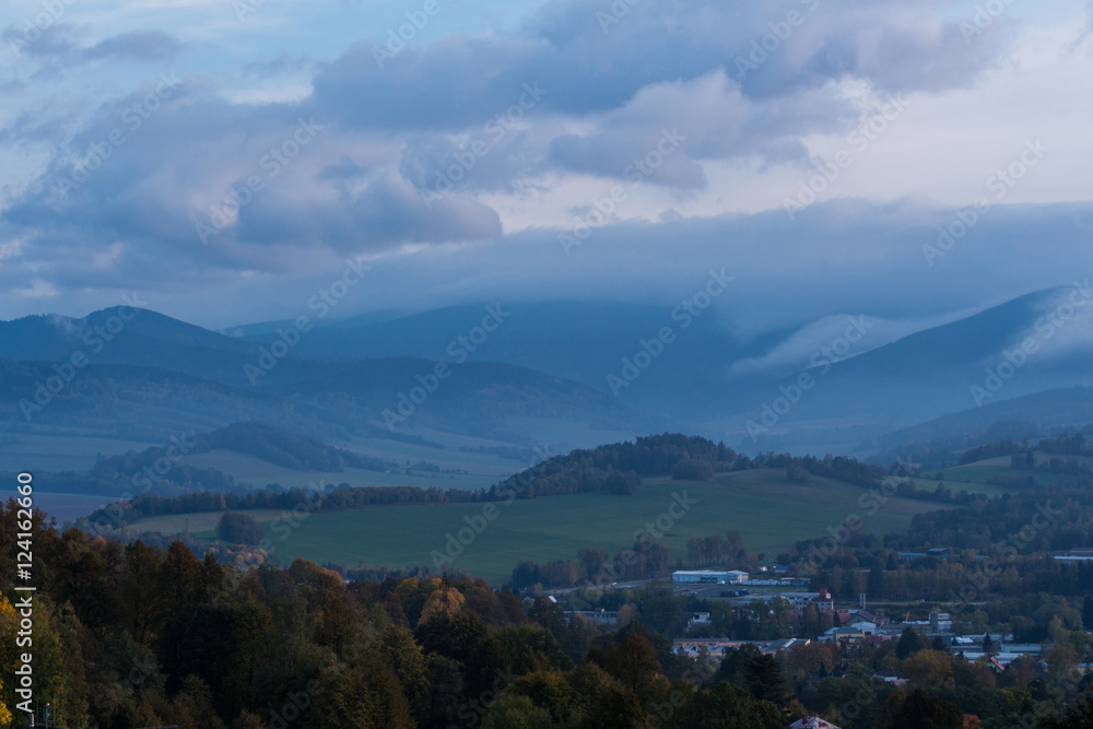 Summer landscape in mountains and the dark blue sky with clouds