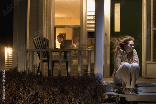 Woman Sitting Outside Of Her House