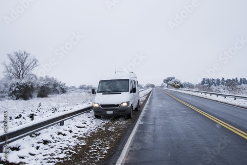 Camper Van Stopped On The Side Of A Snowy Road Near Tucuman; Tucuman, Argentina photo
