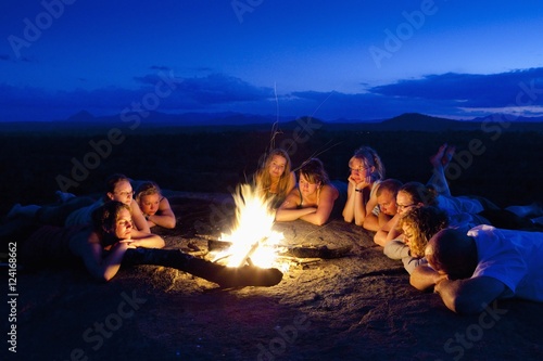 A Group Of People Laying By A Campfire; Manica, Mozambique, Africa photo