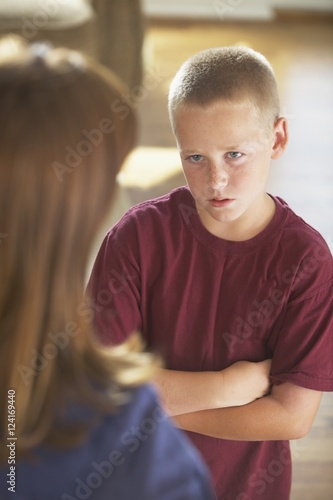 A Boy Looking At His Mother With His Arms Crossed