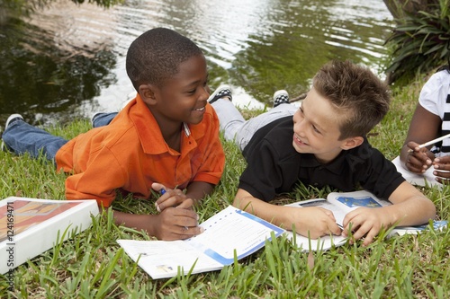 Fort Lauderdale, Florida, United States Of America; Two Boys Doing School Work In The Park photo