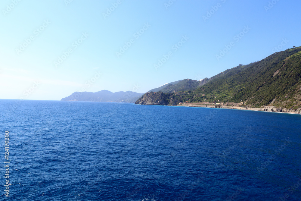 Rocky coast and Cinque Terre village Corniglia and Mediterranean Sea, Italy Rocky coast and Cinque Terre village Corniglia and Mediterranean Sea, Italy