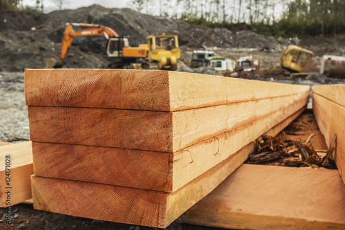 A neat stack of fresh lumber is shown on a side profile revealing the raw grain of the log and texture in the lumber planks ready for construction; Port McNeill, British Columbia, Canada photo