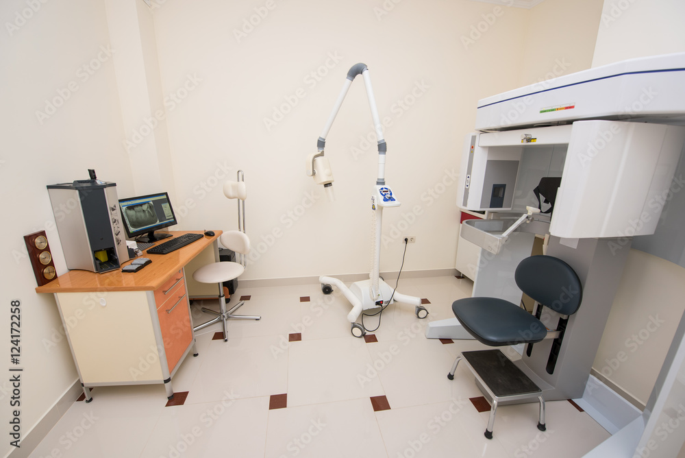 Dentistry office. Cabinet with modern orthopantomograph, dental panoramic x-ray machine to produce images in single shot entire dental system Dentistry office. Cabinet with modern orthopantomograph, dental panoramic x-ray machine to produce images in single shot entire dental system