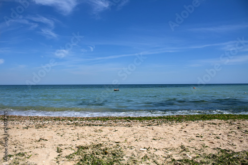 Sky and sea. Sand. Beach. People relax on the beach © timonina