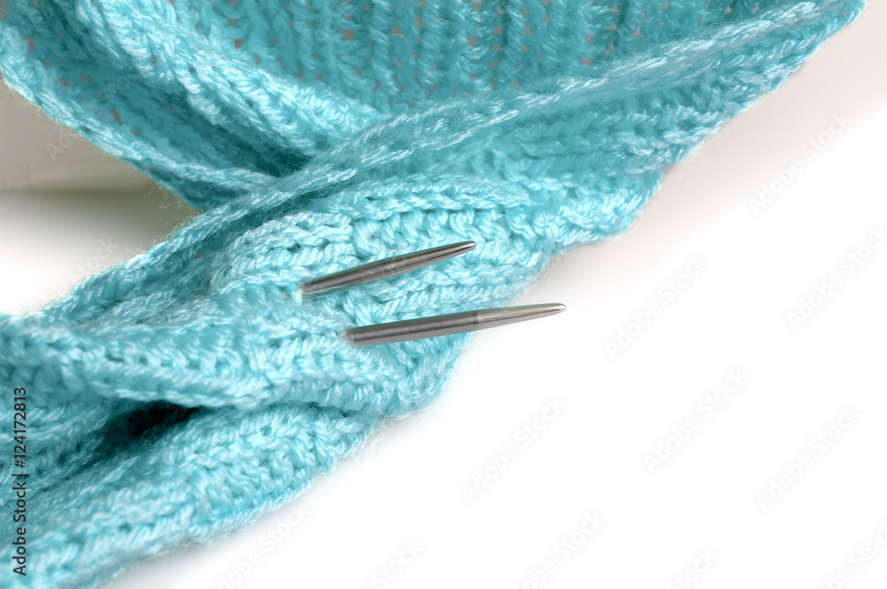 Fototapeta premium Piece of knitting work - blue yarn stitches - macro