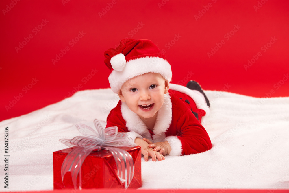 Beautiful little baby celebrates Christmas. New Year's holidays. gift