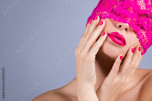 Woman with a pink blindfold on her face