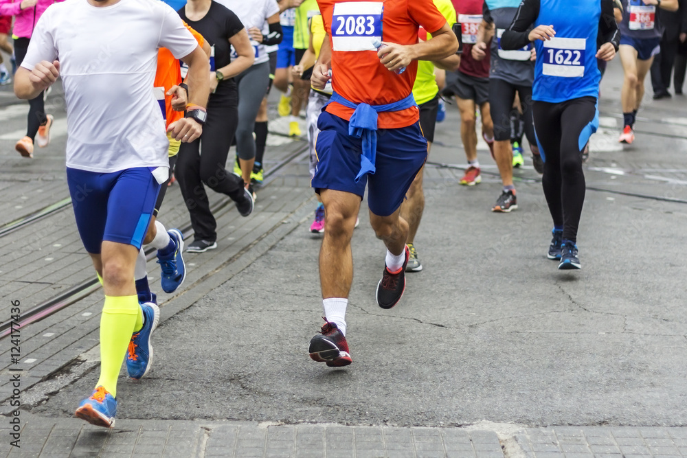 Marathon runners race in city streets, blurred motion Marathon runners race in city streets, blurred motion