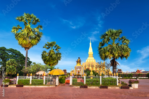 Religious architecture and landmarks. Golden buddhist pagoda of Phra That Luang Temple under blue sky. Vientiane, Laos travel landscape and destinations