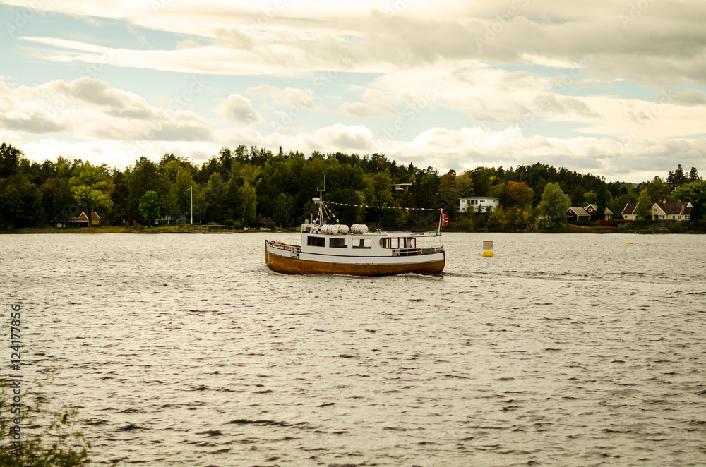 wooden boat floating on norwegian fjord wooden boat floating on norwegian fjord