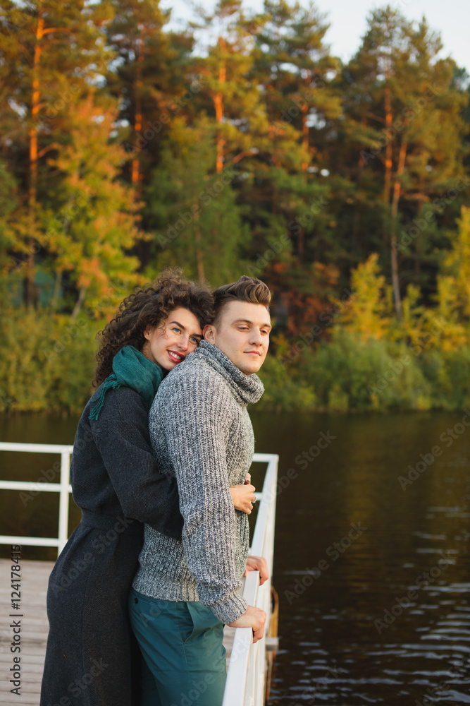 Romantic Couple sitting on the pier Romantic Couple sitting on the pier