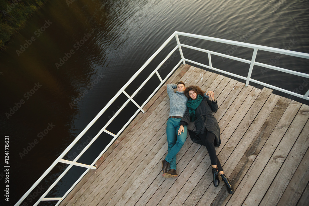 Romantic Couple sitting on the pier Romantic Couple sitting on the pier