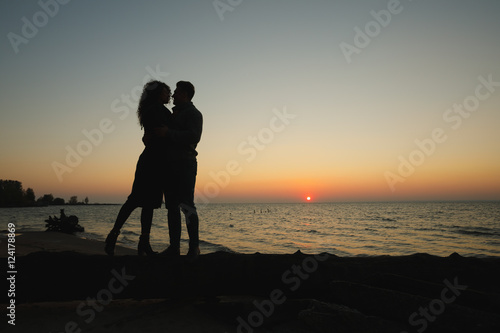 Young beautiful couple in love staying on beach
