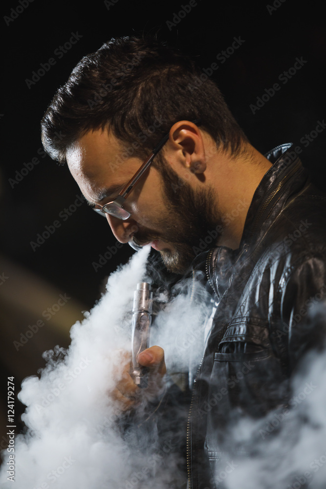 Man with concealed identity smoking a controversial vape.