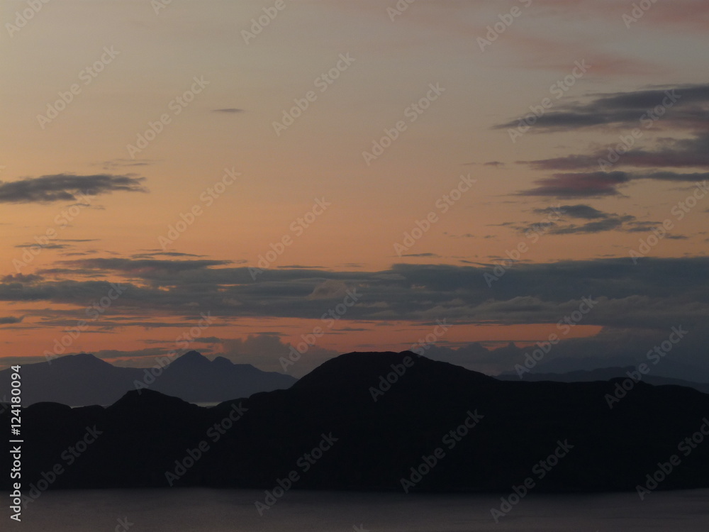Sunset over Ardnamurchan Peninsula, Scotland with Rum and Eigg in the far distance. Photo taken from Gelngorm estate, Mull.