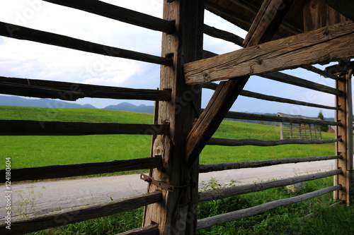 Traditional retro vintage wooden hayrack on the lush green Alpine meadow, Slovenia, Europe