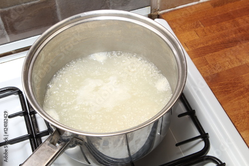 Sauce pan of rice in boiling water on a gas hob