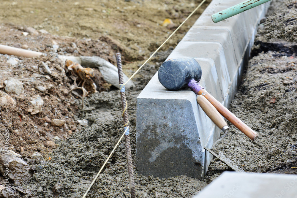 Concrete curb installation. String line level guide is stretched parallel  to the line of course Stock Photo | Adobe Stock