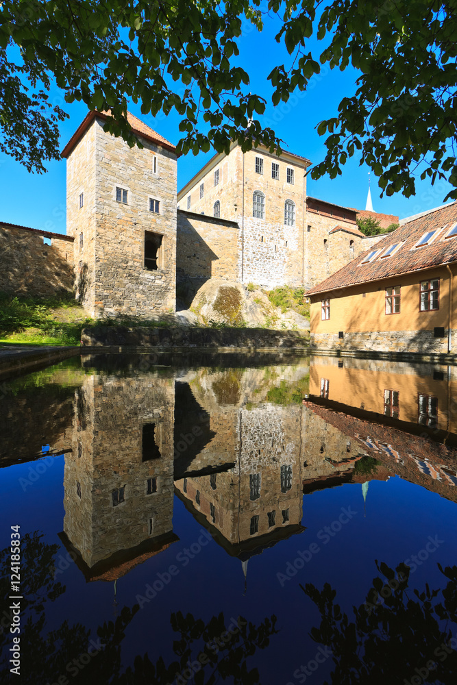 Reflection of the main building towers in the pool of water in Akershus fortress in Oslo, Norway