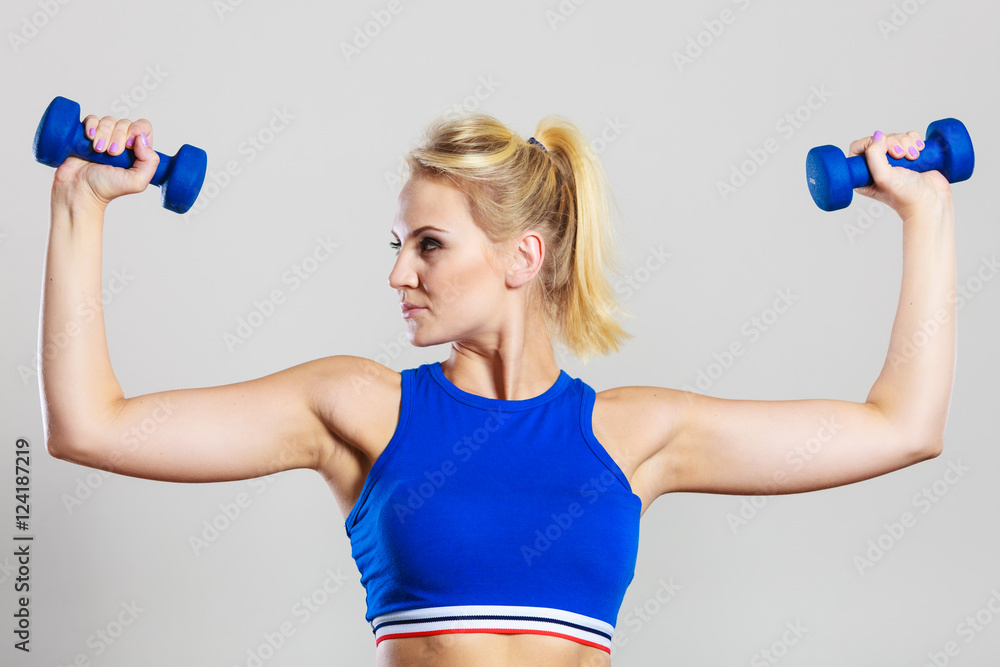 Fit woman lifting dumbbells weights Fit woman lifting dumbbells weights
