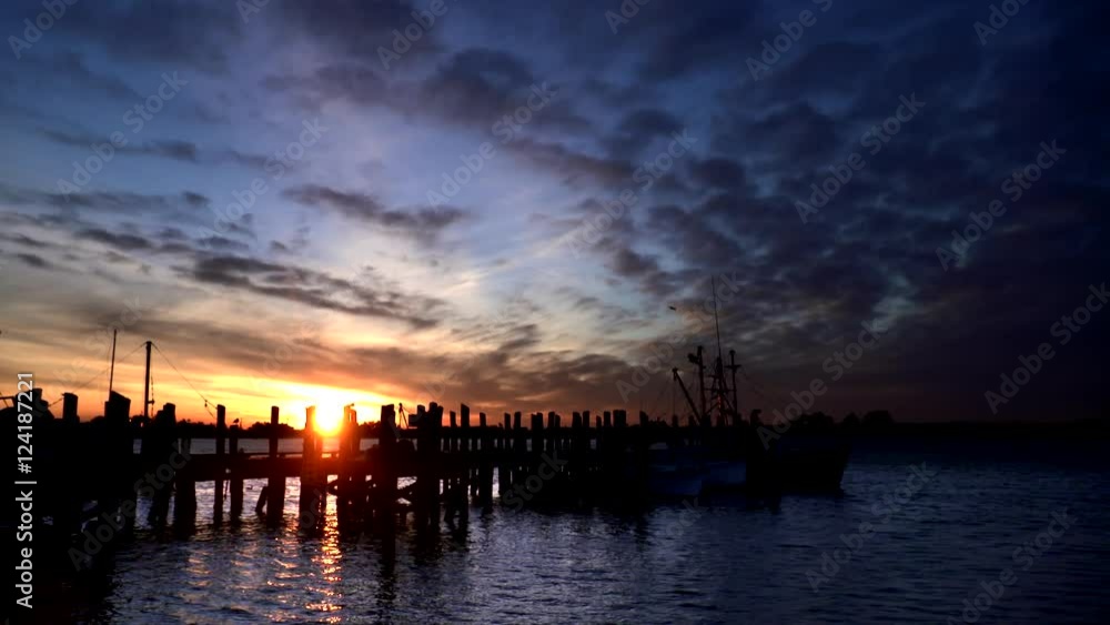 Scenic view of dramatic sky with silhouetted pier during sunset Scenic view of dramatic sky with silhouetted pier during sunset