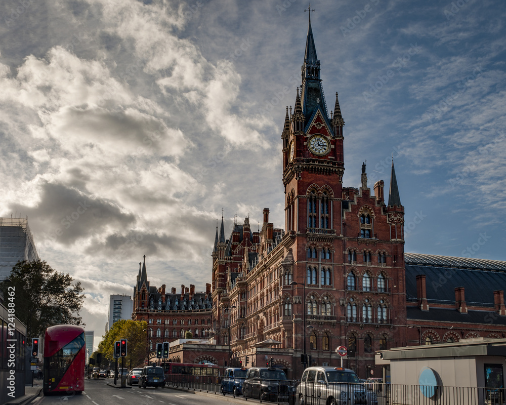 Exterior shot of St Pancras international train and underground station with a red bus and black cab taxi in London, England, UK