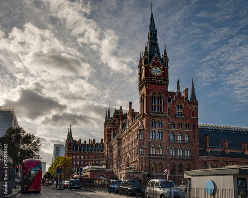 Exterior shot of St Pancras international train and underground station with a red bus and black cab taxi in London  England  UK