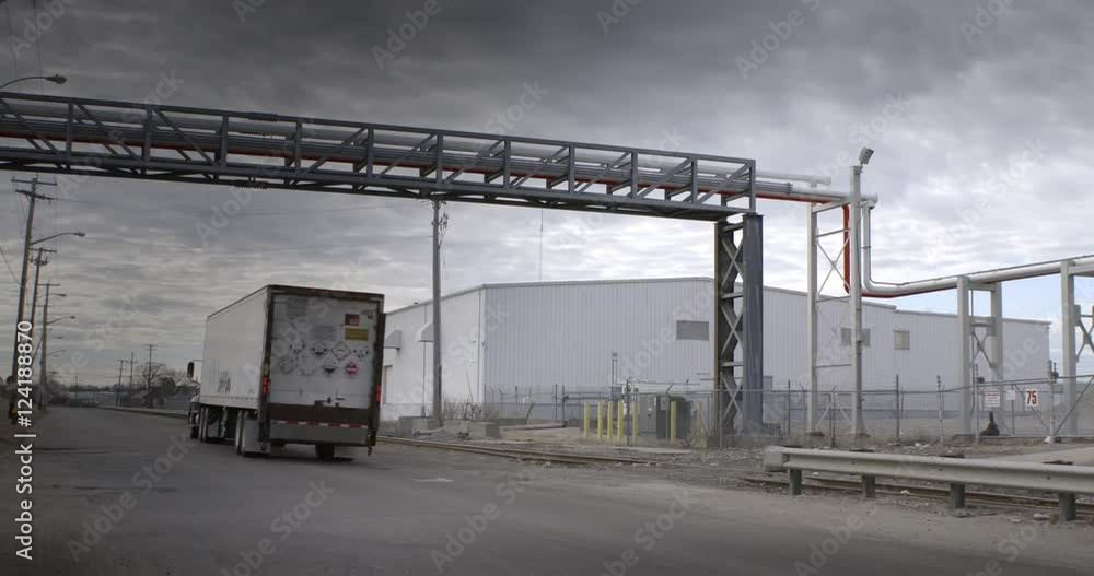 Trailer truck driving on road in an industrial area Trailer truck driving on road in an industrial area