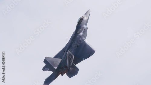 Tracking shot of fighter jet flying in the sky photo