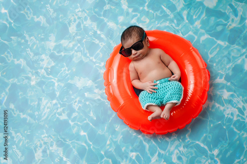 Newborn Baby Boy Floating on a Swim Ring