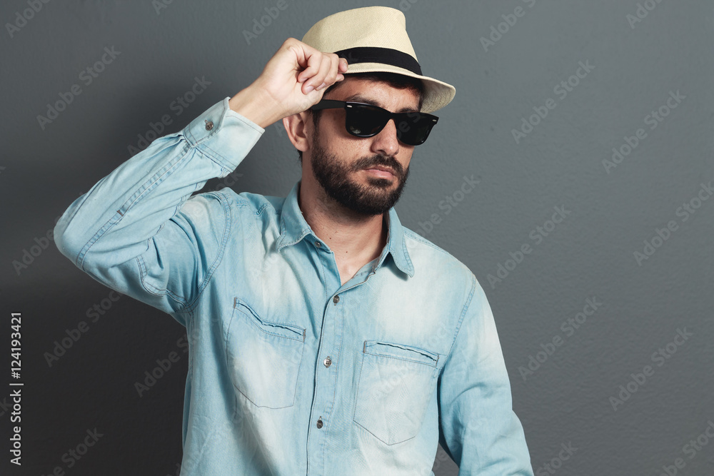 Young hipster bearded man wearing hat - gray background Young hipster bearded man wearing hat - gray background