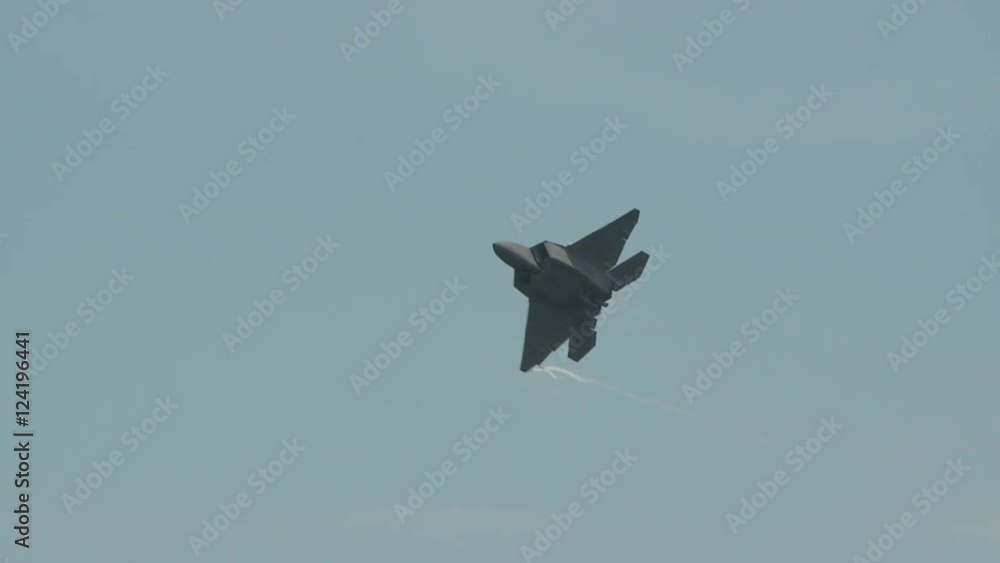 Tracking shot of fighter jet flying in blue sky Tracking shot of fighter jet flying in blue sky